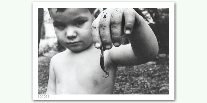 photograph of boy with worm
