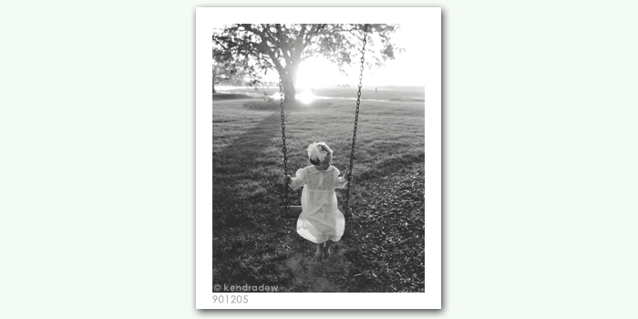 photograph of girl on swing