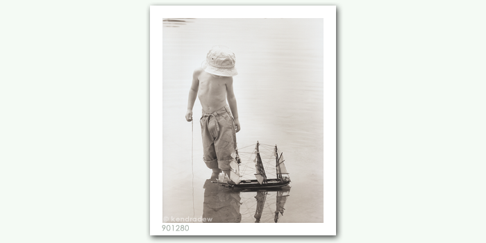 photograph of boy with boat