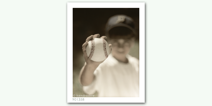 photograph of boy with baseball