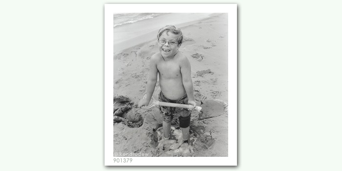 photograph of boy on beach