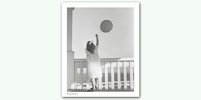 photograph of girl with balloon