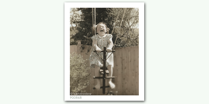 photograph of girl on pull swing