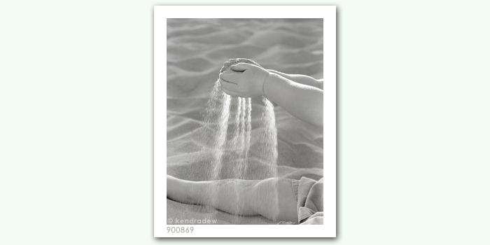 photograph of girl straining sand