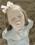 photograph of girl blowing bubble
