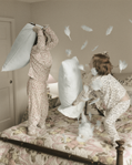 photograph of girls in pillow fight
