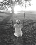 photograph of girl on swing
