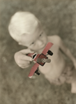 photograph of boy with plane