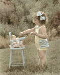 photograph of girl feeding doll