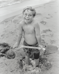 photograph of boy on beach
