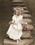 photograph of girl in dress climbing steps