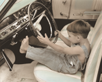 photograph of boy in car