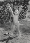 photograph of girl and sprinkler