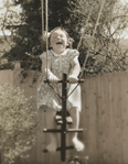 photograph of girl on pull swing