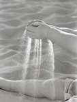 photograph of girl straining sand